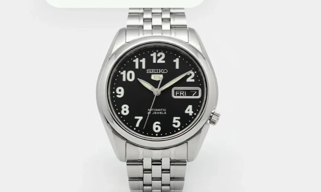 Seiko SNK381K1 automatic watch featuring a black dial and stainless steel bracelet